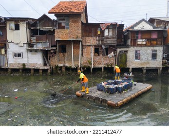 The Janitor Cleans The River. The Orange Team From The DKI Jakarta Cleaning Service Cleans The Grogol Canal.