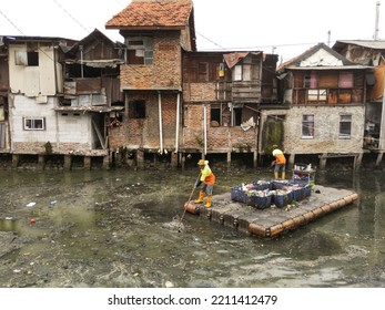 The Janitor Cleans The River. The Orange Team From The DKI Jakarta Cleaning Service Cleans The Grogol Canal.