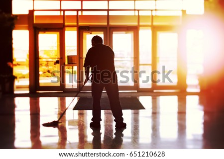 Janitor mopping an office floor, shallow focus, tilt shift image Foto d'archivio © 