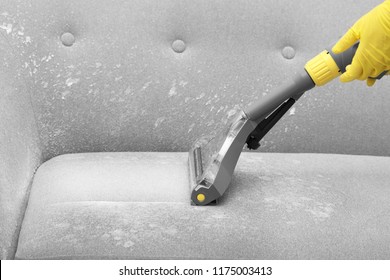 Janitor Removing Dirt From Sofa With Upholstery Cleaner, Closeup