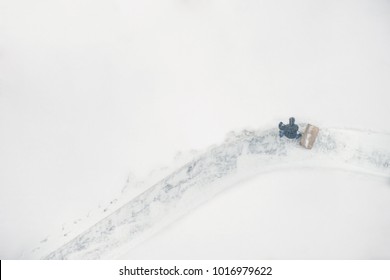 Janitor With A Shovel Cleans The Snow Of City Street. View From Above