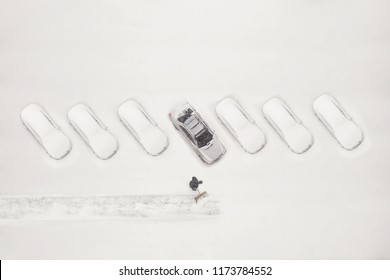 Janitor With A Shovel Cleans The Snow Of City Street. View From Above 