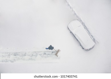 Janitor With A Shovel Cleans The Snow Of Parking Cars. View From Above 