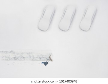 Janitor With A Shovel Cleans The Snow Of Parking Cars. View From Above 