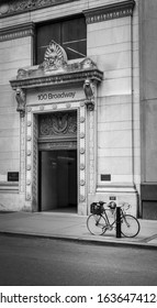 JANUARY 1 2020,NYC, A Black And White Picture Of 100 Broadway Apartment Entrance In NYC With A Bicycle In Front Of The Building.