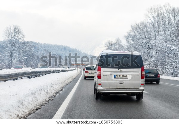 January 12th, 2019 - Salzburg, Austria: Winter\
highway with many different cars stucked in traffic jam due ti bad\
weather conditions. Vehicles on road heavy snowstorm and blizzard\
on cold winter day