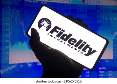 January 15, 2022, Brazil. In This Photo Illustration The Fidelity Investments Logo Displayed On A Smartphone Screen And A Stock Market Graph In The Background