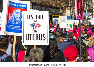 January 19, 2019 San Francisco / CA / USA - Participant to the Women's March event holds "US out of my uterus" sign while marching on Market street in downtown San Francisco