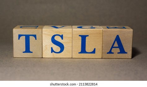 January 19, 2022. New York, USA. Stock Ticker Symbol Of Tesla TSLA Made Of Wooden Cubes On A Gray Background.