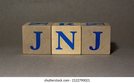 January 19, 2022. New York, USA. Stock Ticker Symbol Of Johnson  Johnson JNJ, Made Of Wooden Cubes, On A Gray Background.
