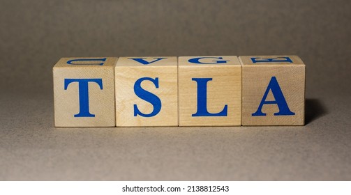 January 19, 2022. New York, USA. Stock Ticker Symbol Of Tesla TSLA Made Of Wooden Cubes On A Gray Background.