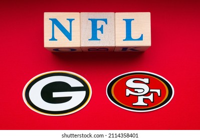 January 20, 2022. Green Bay, Wisconsin. The Emblems Of The Football Clubs Of The Playoffs Of The National Football League San Francisco 49ers And Green Bay Packers On A Red Background.