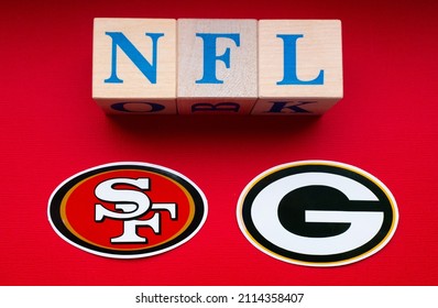 January 20, 2022. Green Bay, Wisconsin. The Emblems Of The Football Clubs Of The Playoffs Of The National Football League San Francisco 49ers And Green Bay Packers On A Red Background.