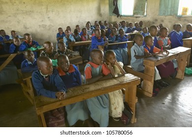 JANUARY 2005 - Children in blue uniforms in school behind desk near Tsavo National Park, Kenya, Africa