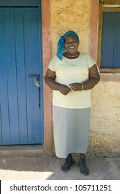 JANUARY 2007 - A Kenyan Woman Smiles In Front Of Pepo La Tumaini Jangwani, HIV/AIDS Community Rehabilitation Program, Orphanage & Clinic.  Nairobi, Kenya, Africa