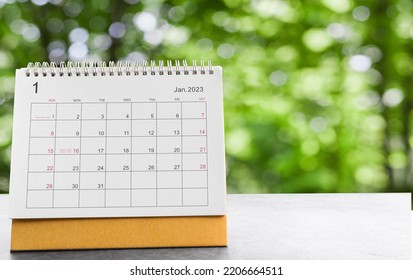 January 2023 desk calendar for planners and reminders on a black table on the natural background green . - Shutterstock ID 2206664511