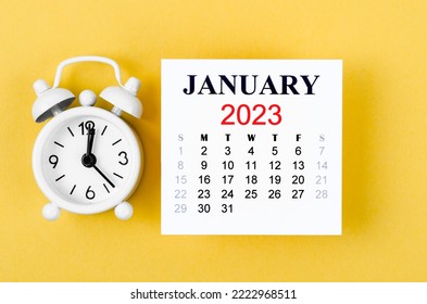 January 2023 Monthly calendar for 2023 year with alarm clock on yellow background. - Shutterstock ID 2222968511