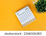 January 2024 desk calendar on yellow background. Directly above. Flat lay. Copy space.