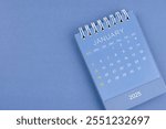 January 2025 calendar on blue color background. Desk calendar for planning and organizing.