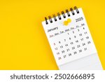 January 2025 Monthly desk calendar for 2025 year with thumbtack on yellow background.