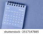 January 2025 Monthly desk calendar for 2025 year on blue color background.