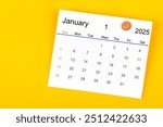 January 2025 and wooden push pin on yellow background.