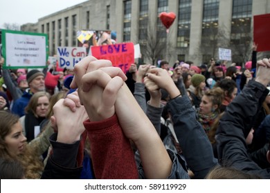 January 21st 2017: Washington D.C.- Two protesters hold hands in solidarity as the Women's March Rally in Washington D.C. was ending and protesters were gearing up to begin marching on the Capitol.