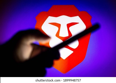 January 22, 2021, Brazil. In This Photo Illustration The Brave Browser Logo Seen In The Background Of A Silhouette Hand Holding A Mobile Phone