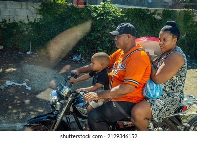 January 27th 2020 - Puerto Plata, Dominican Republic.  A Family Shares A Motorcycle Traveling Through A Village Near Puerto Plata In The Dominican Republic. 