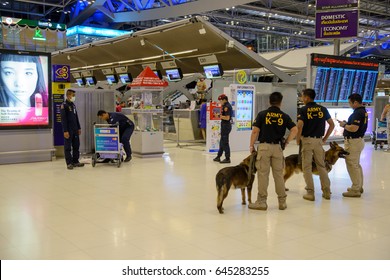 January 29, 2017. Police and army canine units investigates a suspicious suitcase left on a trolley at Suvarnabhumi Airport, Bangkok, Thailand. Security and terrorism editorial concept.