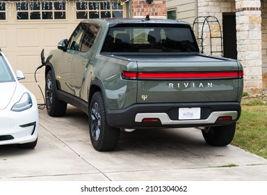 January 2nd 2022 - Austin , Texas , USA: Rivian Electric Truck Parked In Front Of Suburb Home Charging 