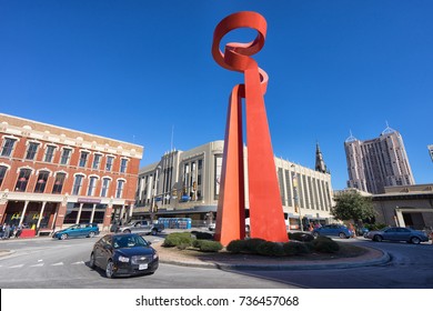 January 3, 2016 San Antonio,  Texas, USA: Traffic Is Passing By The Bright Red Colour Torch Of Friendship Structure In Downtown Area