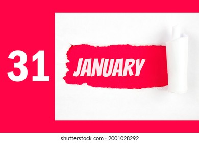 January 31st . Day 31 of month, Calendar date. Red Hole in the white paper with torn sides with calendar date. Winter month, day of the year concept