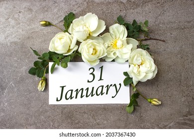 January 31st . Day 31 of month, Calendar date. White roses border on pastel grey background with calendar date. Winter month, day of the year concept