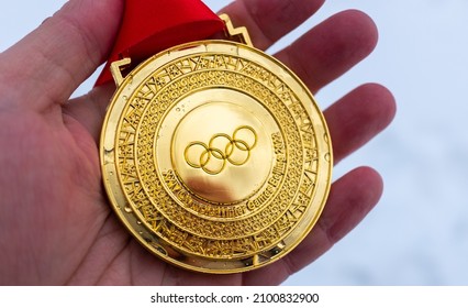 January 4, 2022, Beijing, China. Gold medal of the XXIV Olympic Winter Games in the palm of your hand.