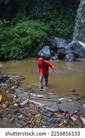 January 5, 2020, Magelang, Central Java, Indonesia.
Someone Wearing A Red Jacket Is Playing In The River After The Flood, And There's A Lot Of Trash