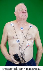 January 7, 2020 - New Cumberland, PA, USA - Man Wearing Heart Portable Heart Monitor At Home Against Removable Green Screen.