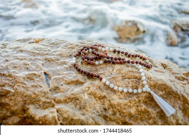 Japa Mala, Prayer Beads. Mantra Meditation Technique By The Sea. Hinduism And Buddhism