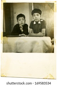 JAPAN - 1950s: An Antique Photo Shows Two Boys At The Table