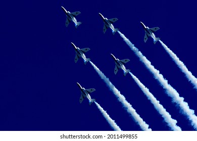 Japan Air Self Defense Force aerobatic team Blue Impulse performing in deep blue sky