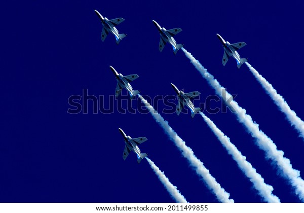 Japan Air Self Defense Force aerobatic team\
Blue Impulse performing in deep blue\
sky
