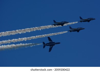 Japan Air Self-Defense Force aerobatic team Blue Impulse flying in deep blue sky