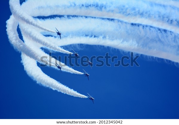 Japan Air Self-Defense Force aerobatic team\
Blue Impulse performing in deep blue\
sky