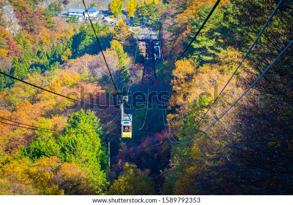 Japan. The\
City Of Kofu. Cable car in Kofu canyon. View of autumn canyon and\
Japanese cable car. Autumn in Japan. The Nature Of Japan. Travel by\
cable car. Kofu gorge from a\
height.
