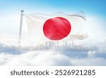 Japan flag wavering in beautiful clouds with building skyline. The flag with drone shot in beautiful sky. Japan national flag for independence day.