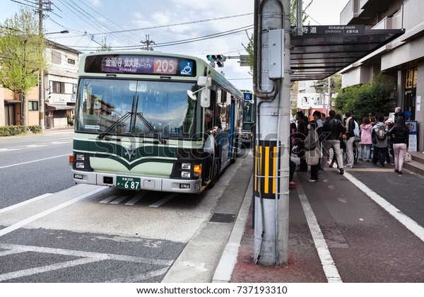 JAPAN, KYOTO-CIRCA APR, 2013: Asian passenger get\
the bus on bus stop of old part of Kyoto city. Japanese public\
transport network