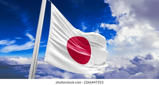 Japan national flag cloth fabric waving on beautiful blue sky.