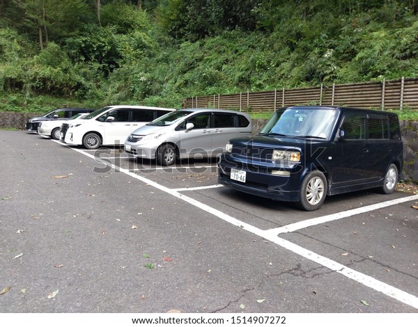 Japan - September 26, 2019: Cars parked in\
reverse in Nanasawa Forest Park. It is common for Japanese to park\
their cars in reverse (back in)\
parking.