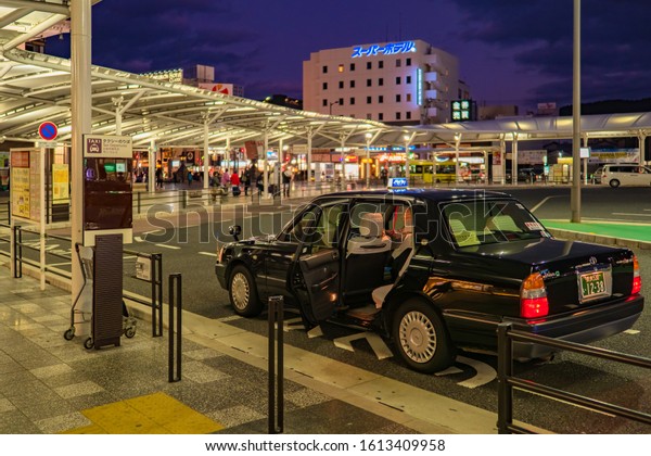Japan. Taxi rank in\
Nara. A black car with an open door is waiting for passengers. Taxi\
in Japan. Transport system of Japan. An unoccupied taxi for a trip\
to Nara. 19.11.2019