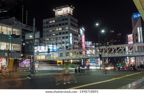 JAPAN, TOKYO - APRIL 19, 2019: Foot traffic\
round Shinjuku train station at\
night
